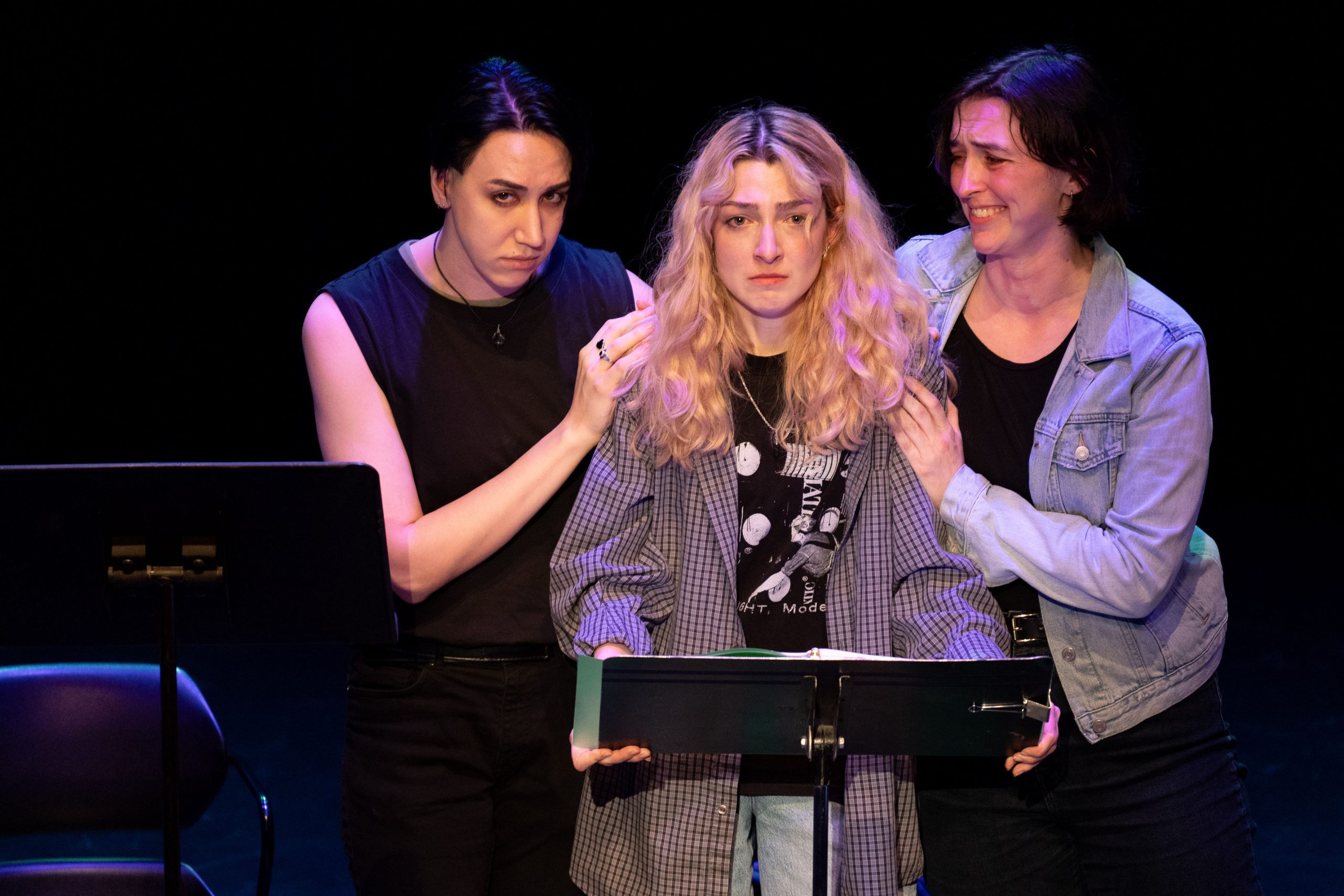 Staged Reading Photo from Vascular Necrosis - Two actors surround the third, who looks distressed.