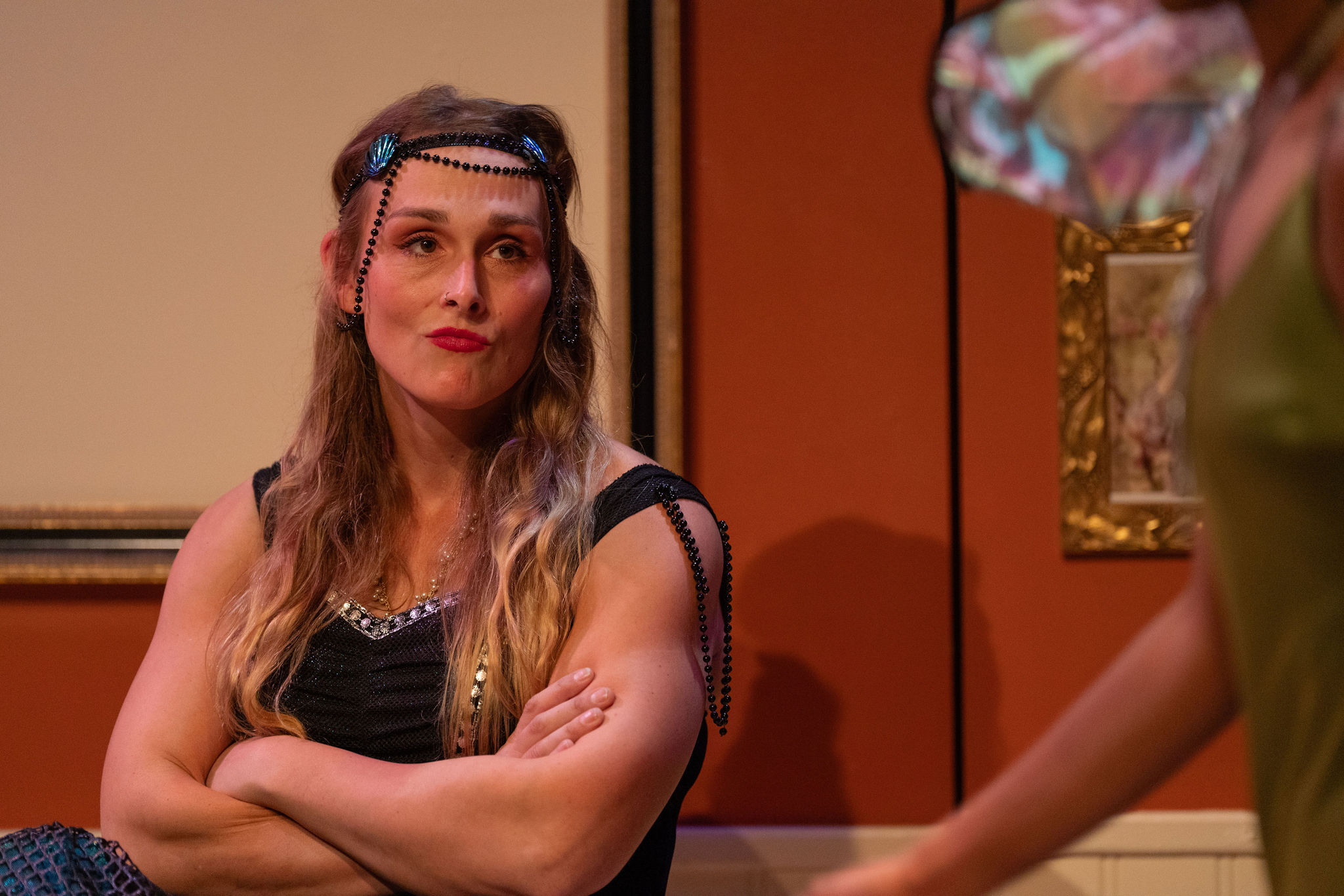 Production Photo of Faye's Room - An actor in a mermaid costume crossing her arms.