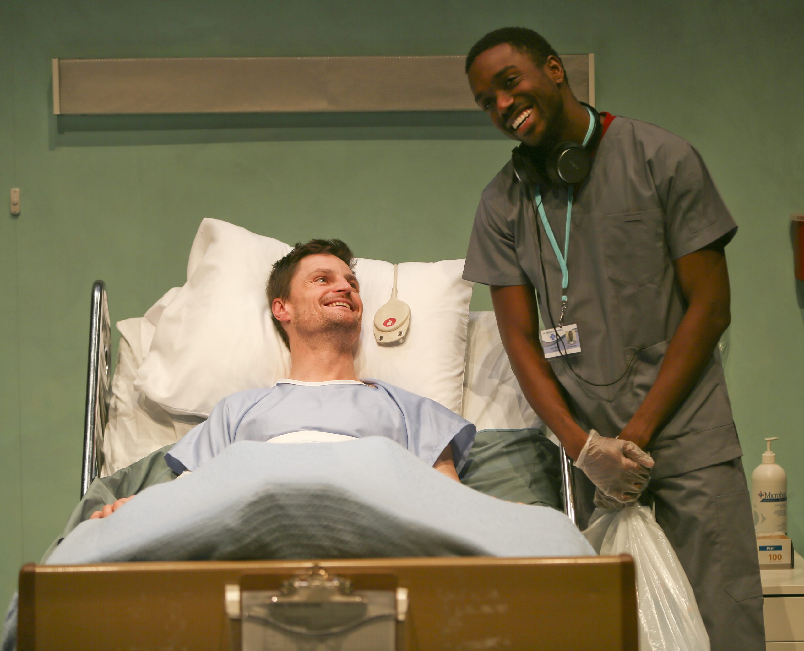 Production Photo from Whose Life is it Anyway? — Two actors, one in a hospital bed, the other a doctor.