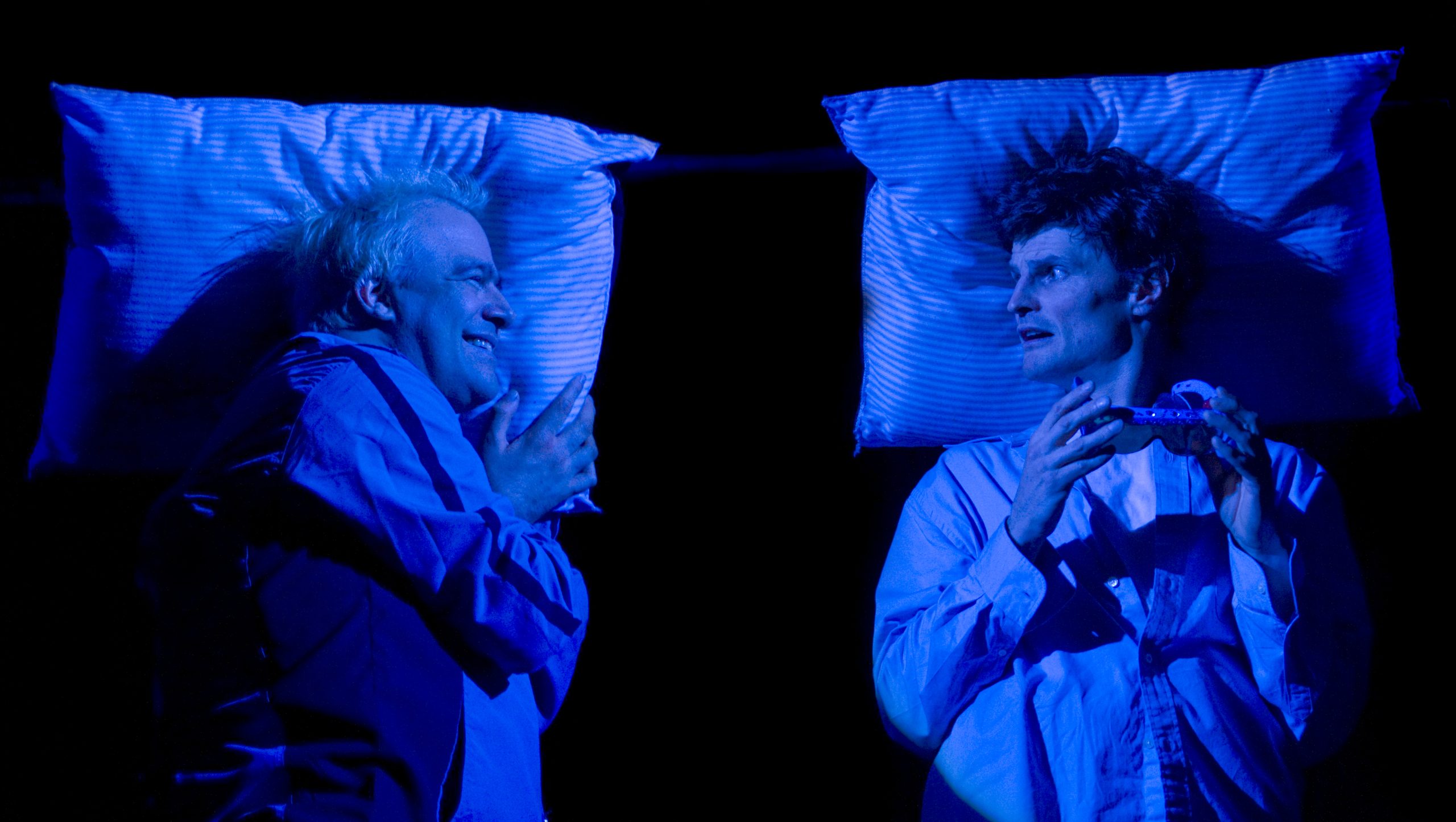 Production Photo from Skydive - Two actors in bed facing each other.